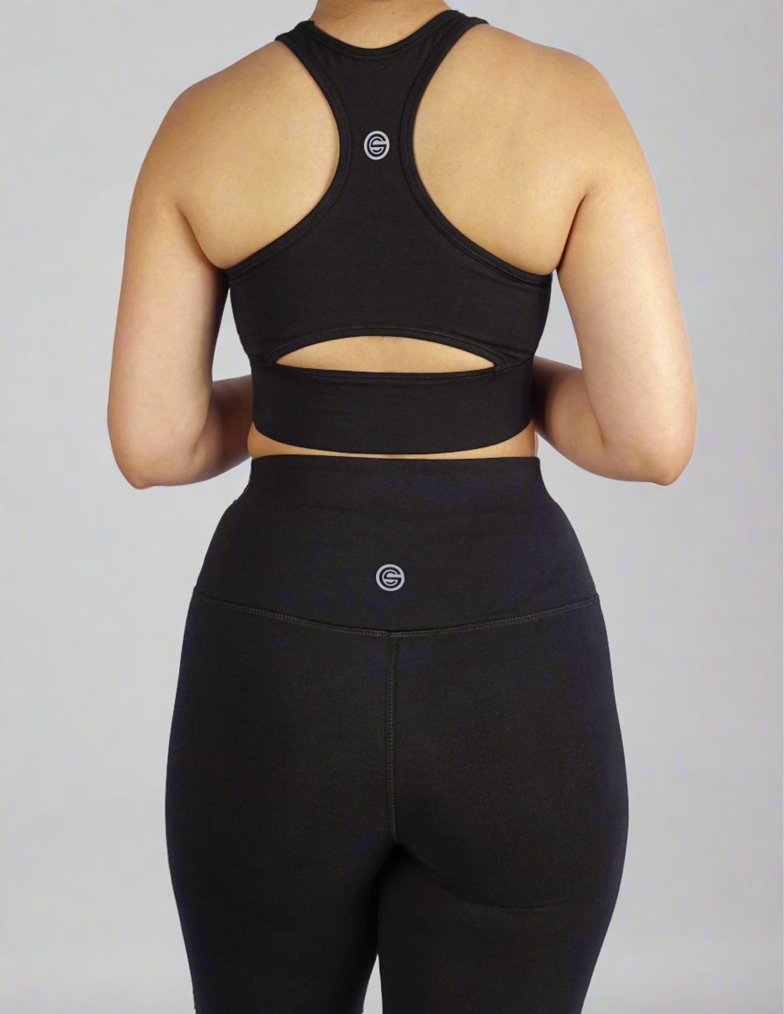 Back view of black sports bra with keyhole cut and side panel stitch for comfort