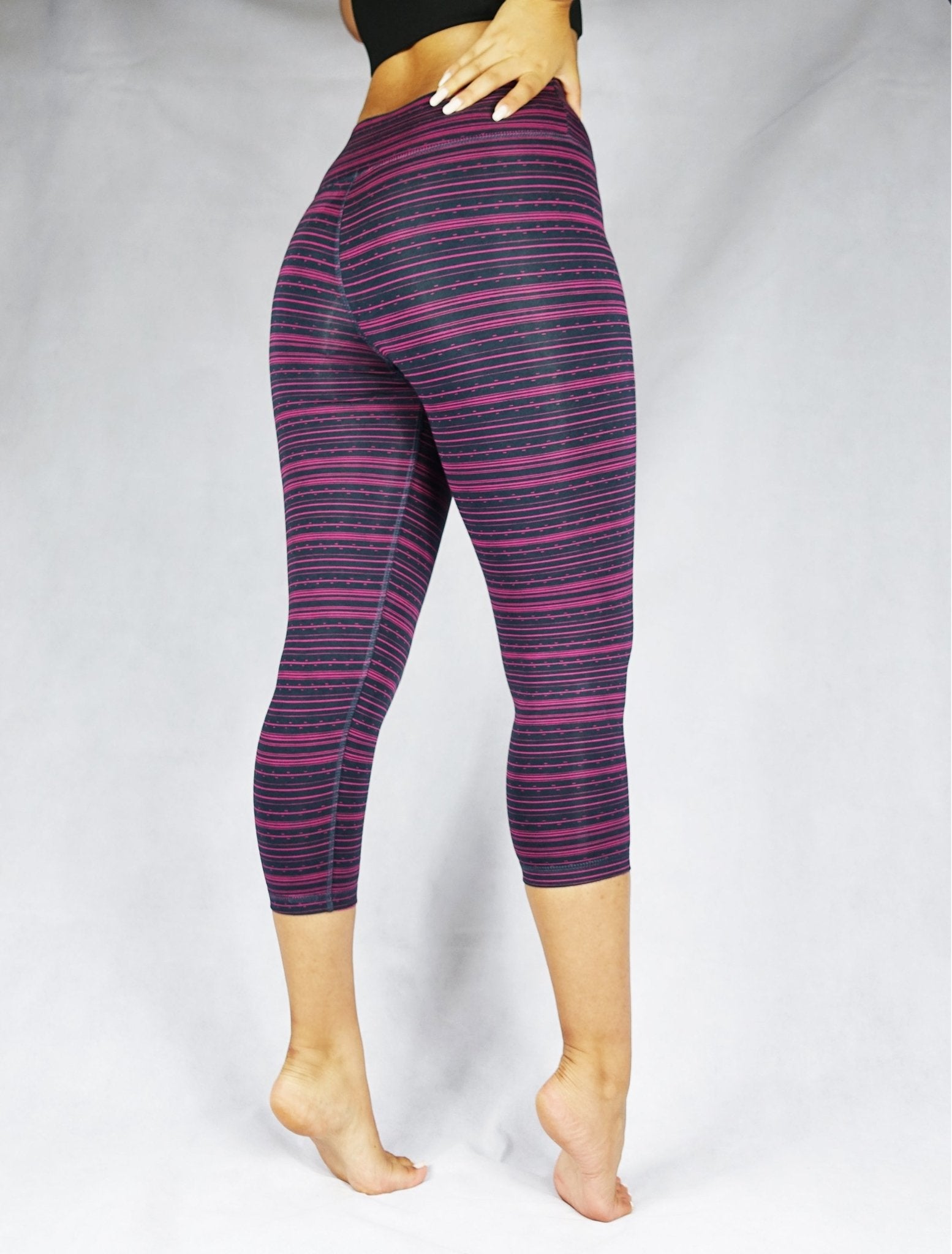 Pink stripe on black crop leggings, side view
